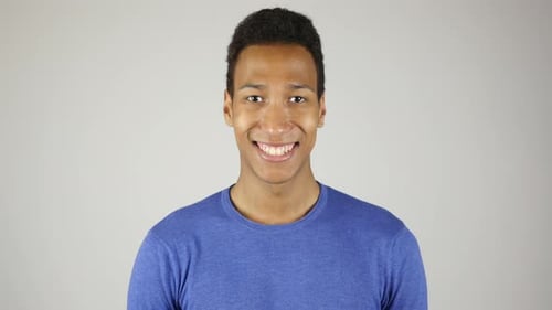 Smiling Young Adult in Blue Shirt Close Up