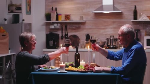 Mature Couple Celebrating Anniversary at Home with Wine
