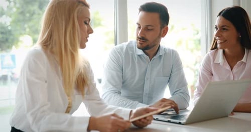 Workteam in Office Working Together on Laptop