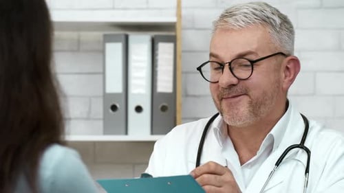 Professional Therapist Talking To Patient Woman Suggesting Treatment In Office