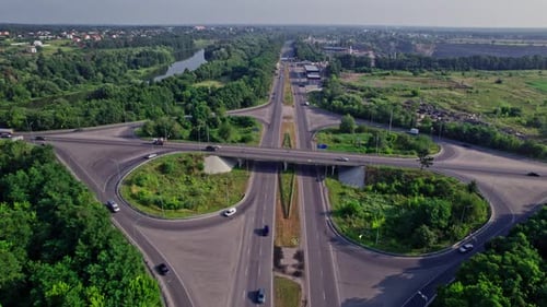 Traffic Driving Over Roundabout with Highway Road Underneath