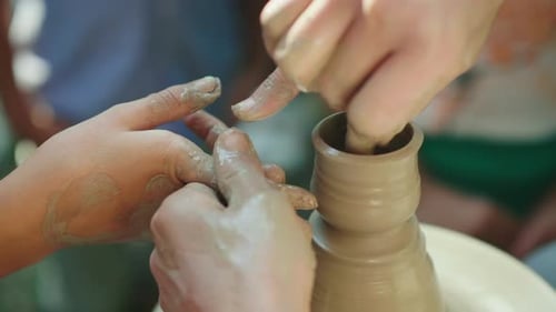 Child and Adult Pottery Wheel Shaping Clay Vase