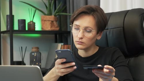 Beautiful businesswoman is using bank credit card for online shopping
