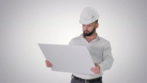 Man Engineer Walking in Helmet Looking at Project of Reconstruction on Gradient Background.