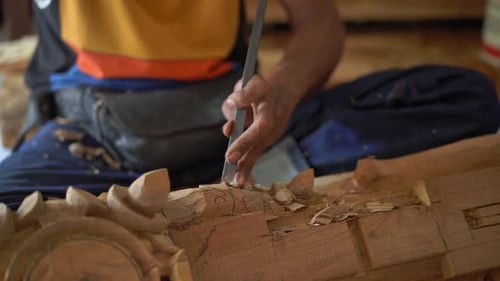 Adult Carving Wood with Chisel and Hammer