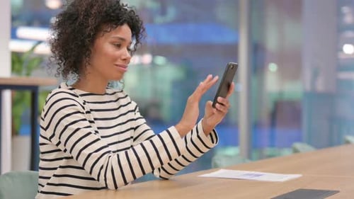 African Woman Using Smartphone in Office