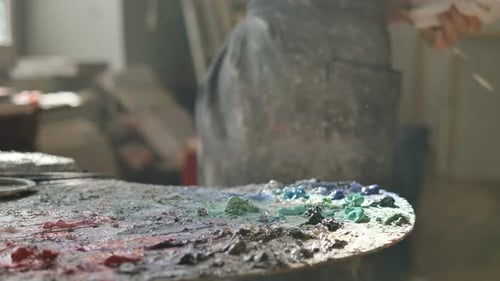 Woman in Dirty Apron Takes Oil Paint Drawing in Art Studio
