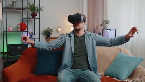 Adult Man Use Virtual Reality Headset Glasses at Home Play 3D Video Game Making Gestures with Hands