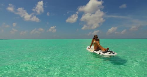 Sexy smiling girls relaxing by the sea on the beach on paradise white sand and blue background 4K