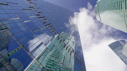 high-rise buildings of business centers against the background of fast-moving clouds