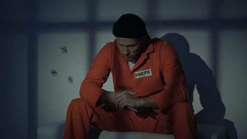 Unhappy Caucasian Male Prisoner Feeling Guilty About Crime, Thinking in Cell