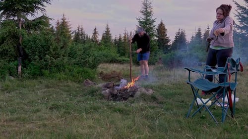 Adults Relaxing by a Cozy Campfire in Nature