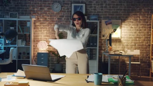 Cute Business Lady Dancing in Office at Night Throwing Papers Having Fun