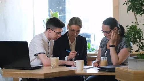 Business Colleagues Having Meeting in a Cafe