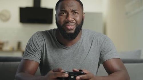 Black Man Playing Video Game at Home. Portrait of Black Guy Holding Play Station