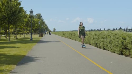 Woman Rollerblading in Park on Sunny Day