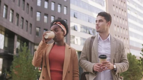 Man and Woman Walking and Talking in City