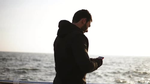 Man Exercising Near the Ocean During Sunrise