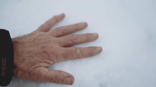 Adult Male Hand Touching Snow in Winter