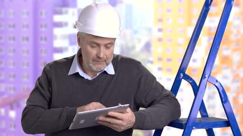 Mature Foreman Working on Pc Tablet.