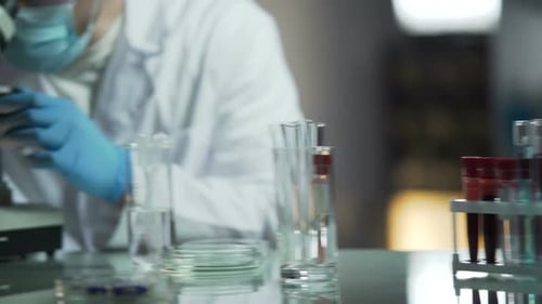 Scientist Working with Microscope in Lab