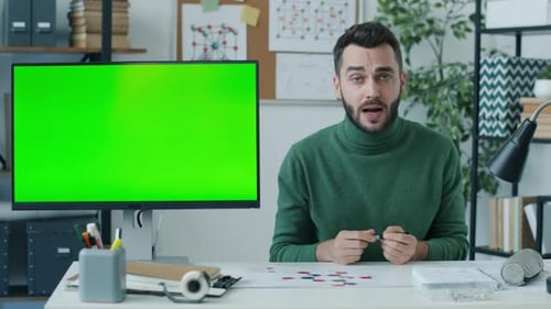 Online School Teacher Pointing at Chroma Key Green Computer Screen Speaking During Remote Lesson