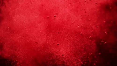 Vivid Red Powder Explosion on Dark Background