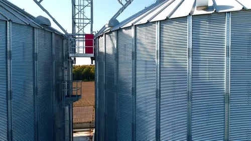 Aerial View of Shiny Grain Silos in Rural Landscape