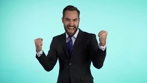 Businessman Celebrating Success, Clenching Fists in Triumph