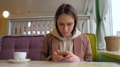 Female Use Smartphone in Cafe