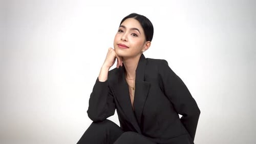 Confident Woman Posing in Black Suit in Studio
