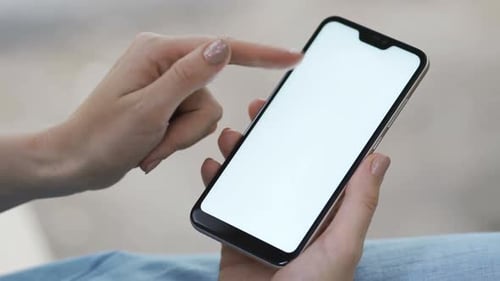 Woman's Hand Using a Smartphone with a White Screen