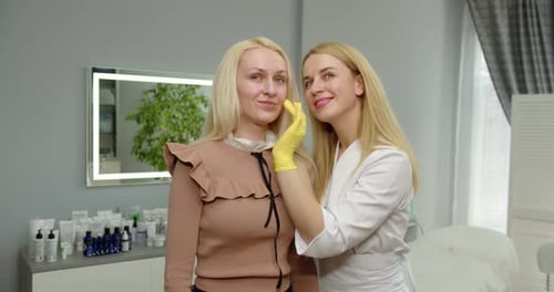 The Blonde Beautician Shows The Result Of Skin Care. Beauty Clinic Concept