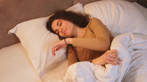 Woman Sleeping Comfortably in Bed