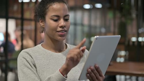 Cheerful African Woman Using Tablet PC