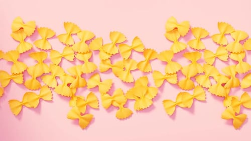 Animated Bow Tie Pasta Pieces on Pink Background