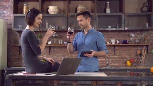Couple Uses Technology and Drinks Wine at Home