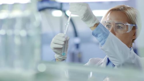 Female Scientist Carrying out Experiment