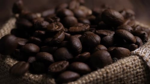 Roasted Coffee Beans Pouring on Burlap Sack