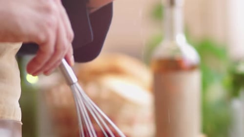 Hands Sprinkle Food Into Bowl With Whisk