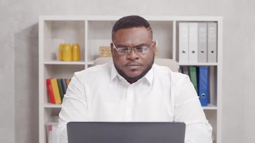 Workplace of freelance worker at home office. Young African-American man.