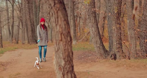 Beautiful and Happy Woman Walks with a Osbaka in the Forest