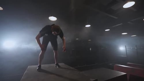 Free Running Young Man Doing a Series of Somersaults on the Training Ground for Parkour and Workout