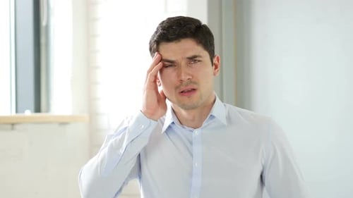 Headache Man with Pain in Head in Office