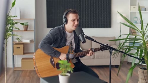 Man Plays Guitar and Sings in Living Room