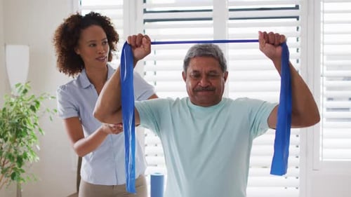 Senior Man Exercising with Resistance Band at Home