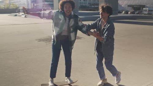 Young Adults Skateboarding Together in the City
