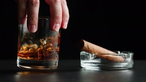 Whisky Drink and Cigar on Dark Table
