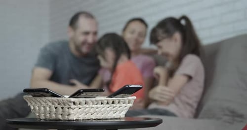 Family Togetherness With Phones Stored in Basket