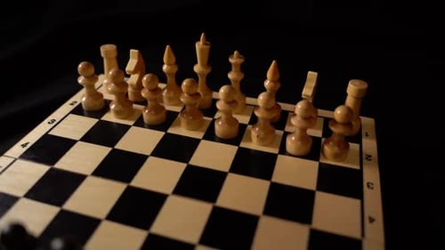 White Wooden Pieces on a Chessboard